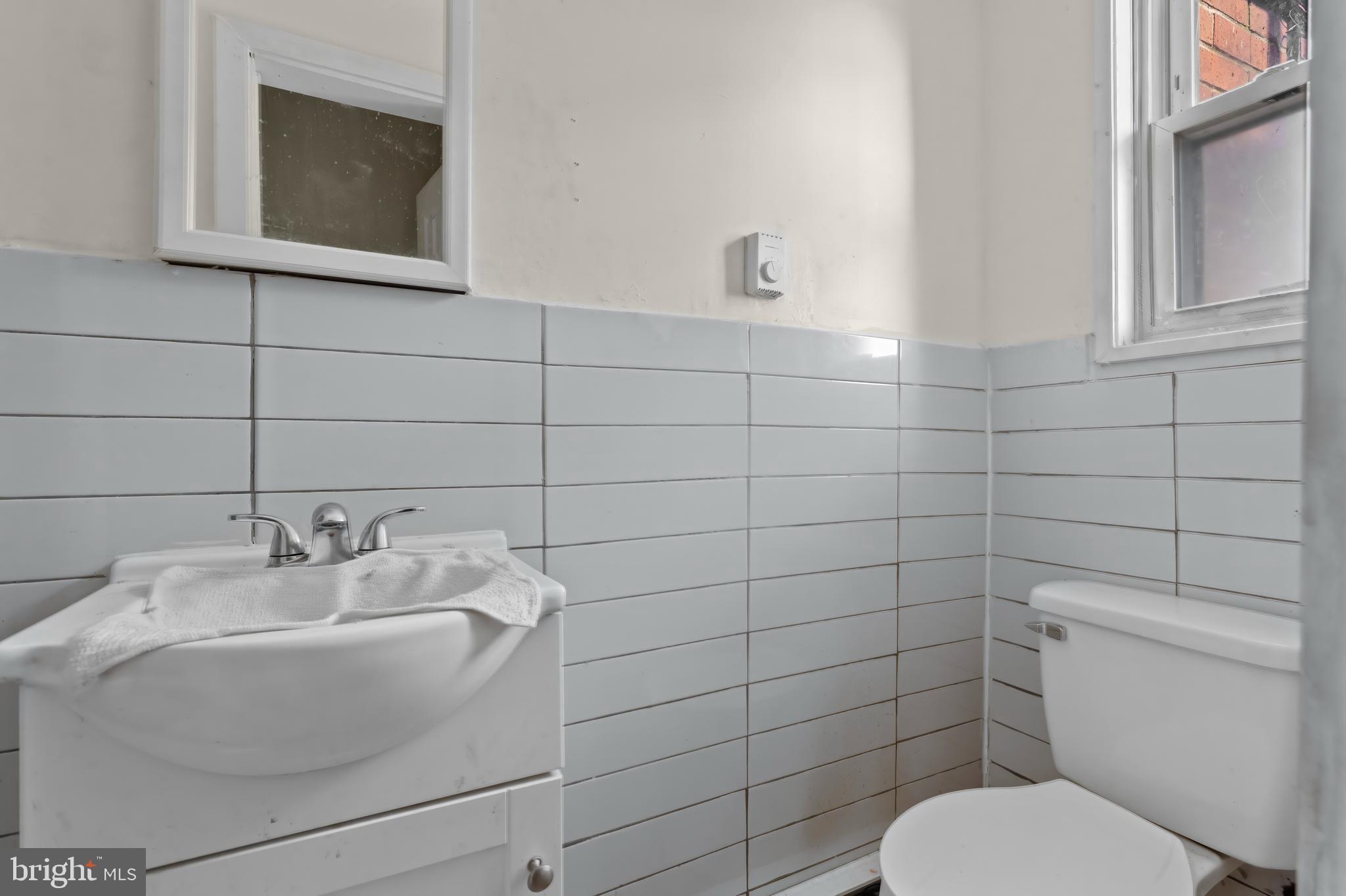 968 Mt Olivet Road Northeast Washington, DC 20002 - Photo 7 of 16 a bathroom with a toilet and sink