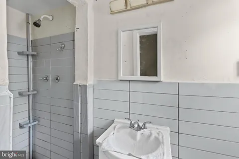 a bathroom with a sink and shower