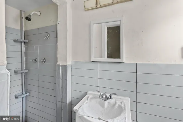 a bathroom with a sink and shower