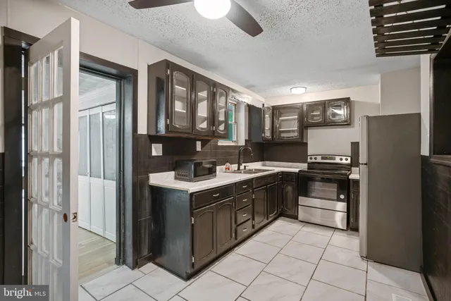 a kitchen with a stove sink and refrigerator