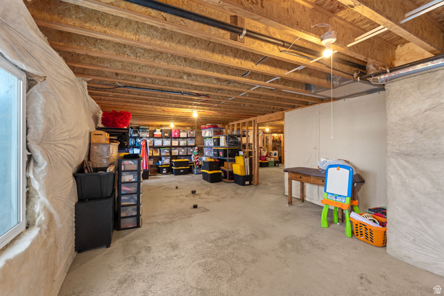 3678 Spiral Springs Road, Unit 204 Tooele, UT 84074 - Photo 37 of 59 Unfinished basement featuring exposed wood joists, concrete flooring, and partial insulation