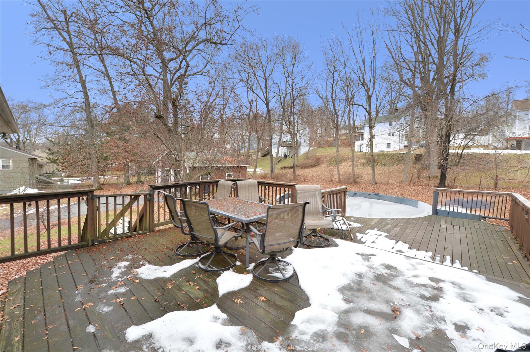 130 Spring Street Goshen, NY 10924 - Photo 23 of 24 a view of a patio with table and chairs with wooden floor and fence