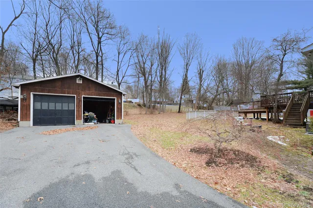 a front view of a house with a yard covered with snow