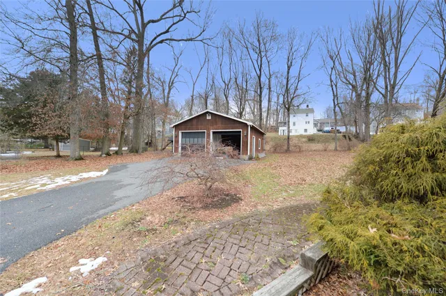 a front view of a house with a yard covered with snow