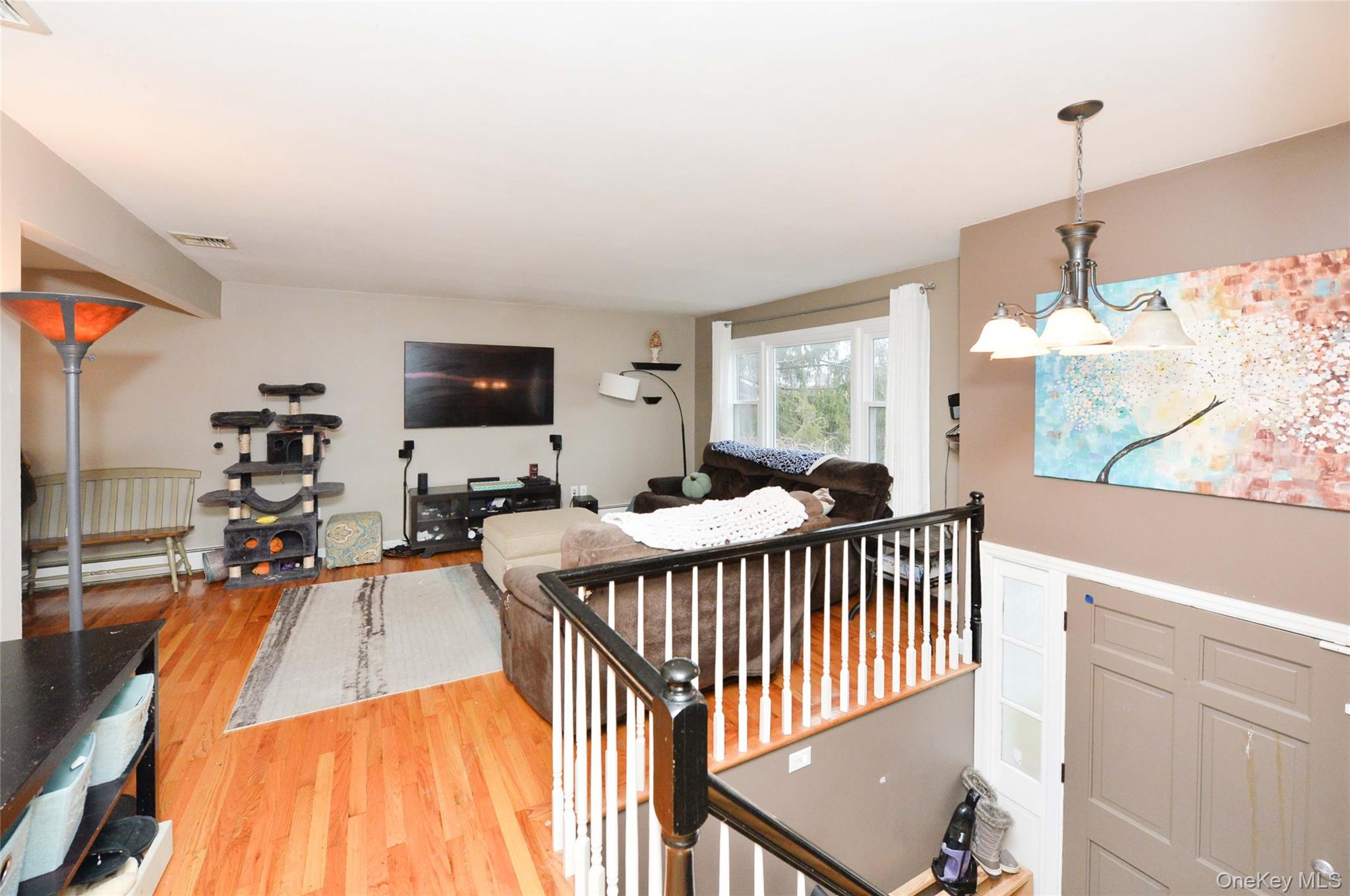 130 Spring Street Goshen, NY 10924 - Photo 5 of 24 a bedroom with furniture and a wooden floor