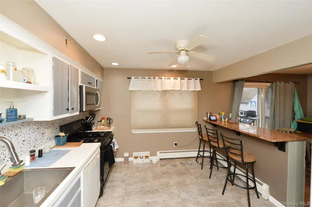 a kitchen that has a sink and a stove in it