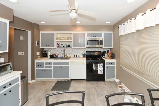 a kitchen with a refrigerator stove top oven and sink