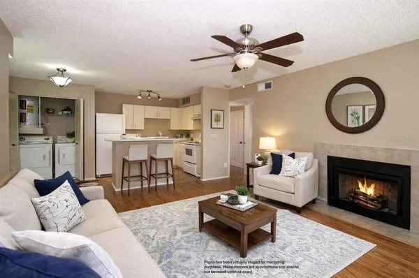 a living room with furniture and a fireplace