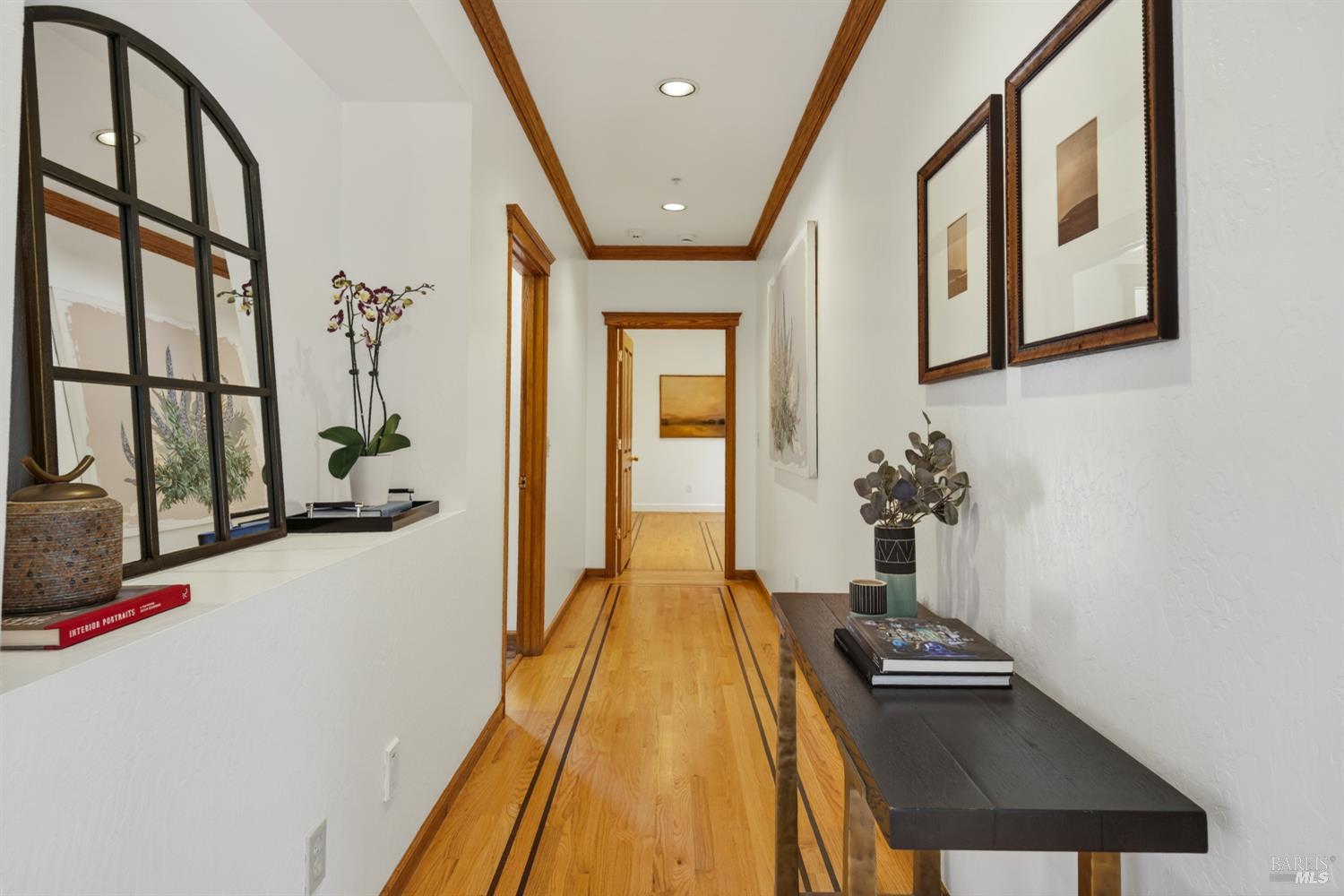 10 Lockton Lane Novato, CA 94945 - Photo 24 of 68 Hallway with arched windows, warm wood floors, and architectural detailing that adds character and continuity to the home.