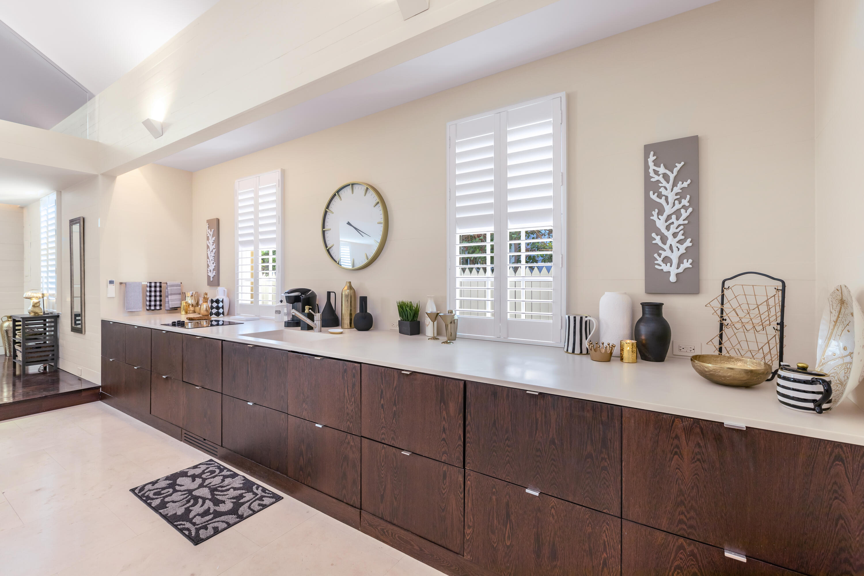711 Elizabeth Street Key West, FL 33040 - Photo 19 of 36 a kitchen with a sink and a clock on the wall