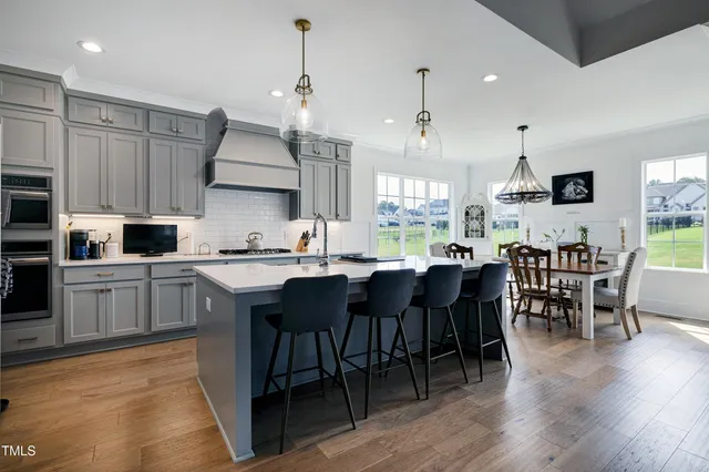 a kitchen with a sink a stove a refrigerator and cabinets