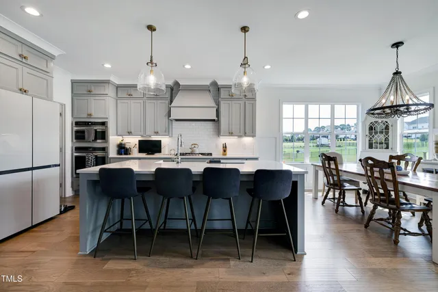 a kitchen with stainless steel appliances granite countertop white cabinets and a stove