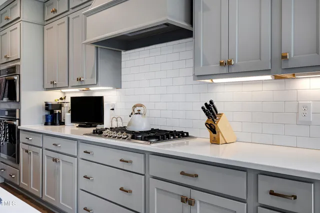 a kitchen with sink cabinets and wooden floor