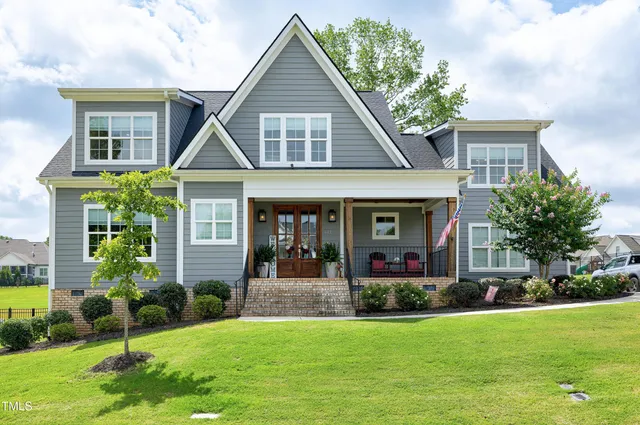 a front view of a house with a yard and porch