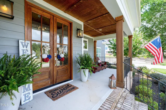 a balcony with wooden floor outdoor seating and outdoor seating