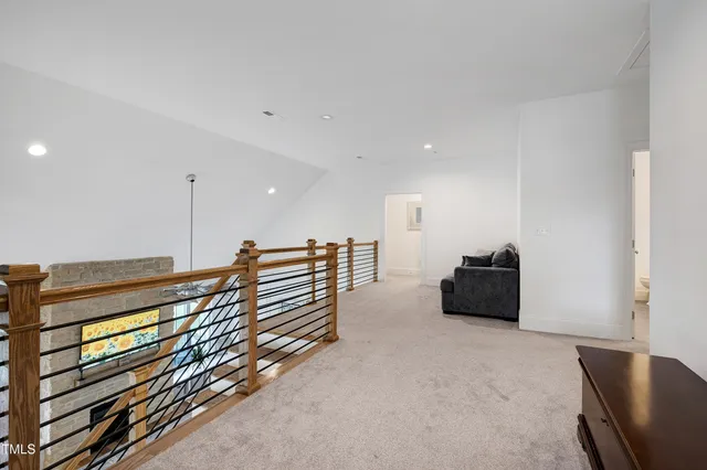 a bedroom with a bed window and a flat tv screen