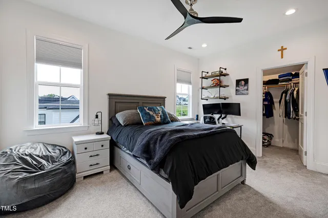 a bed sitting in a spacious bedroom next to a window