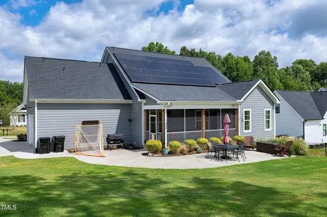 an aerial view of a house with a yard