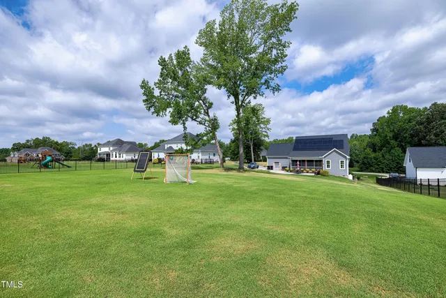 an aerial view of a house with swimming pool garden and mountain view
