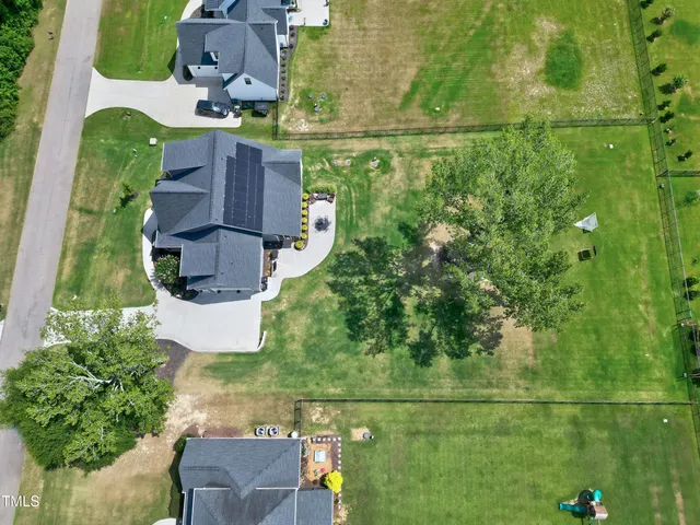 a green field with lots of trees