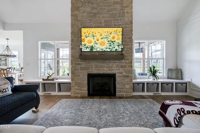 a living room with furniture fireplace and flat screen tv