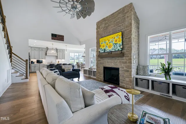 a living room with furniture a fireplace and a large window