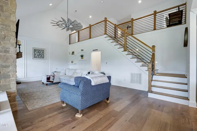 a kitchen with stainless steel appliances granite countertop a table chairs sink refrigerator and cabinets