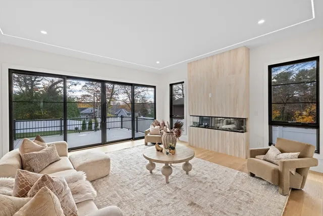 a living room with furniture and large windows