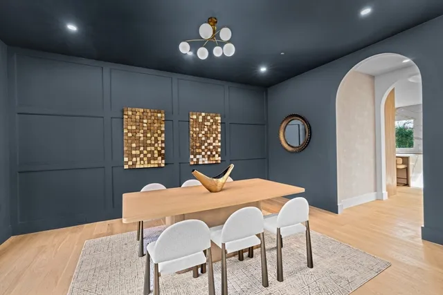 a view of a dining room with furniture and a chandelier