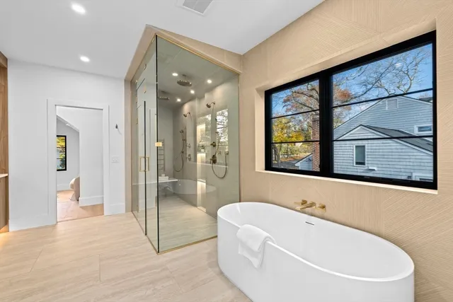 a bathroom with a bathtub and a window