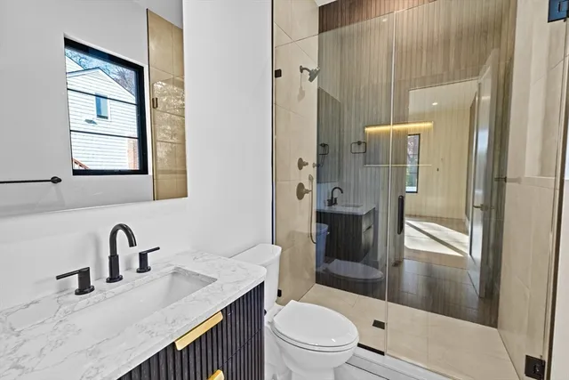 a bathroom with a sink toilet and shower