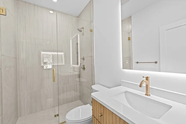 a kitchen with stainless steel appliances granite countertop a sink and a white cabinets