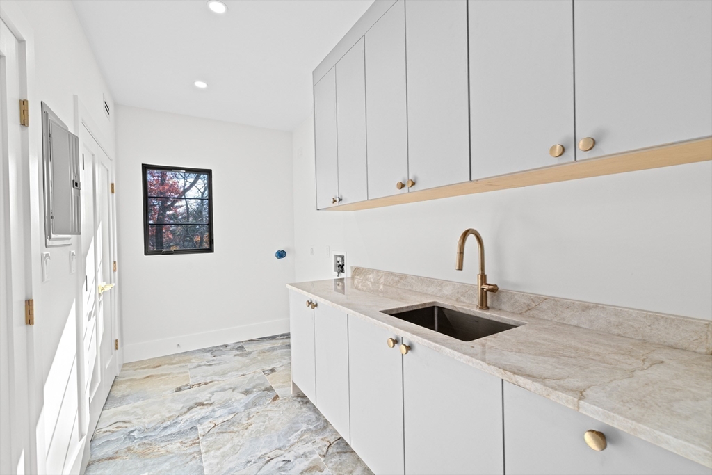 36 Roland Street Newton, MA 02461 - Photo 36 of 42 a kitchen with stainless steel appliances granite countertop a sink and a white cabinets