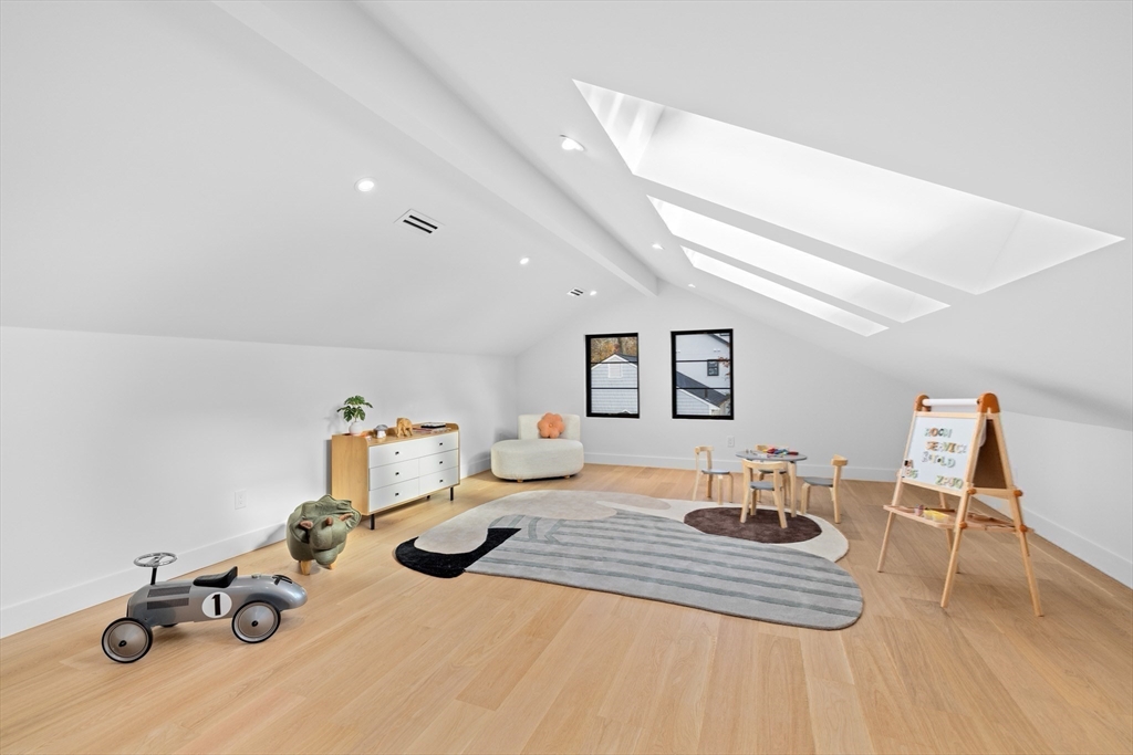 36 Roland Street Newton, MA 02461 - Photo 37 of 42 a bedroom with furniture and wooden floor