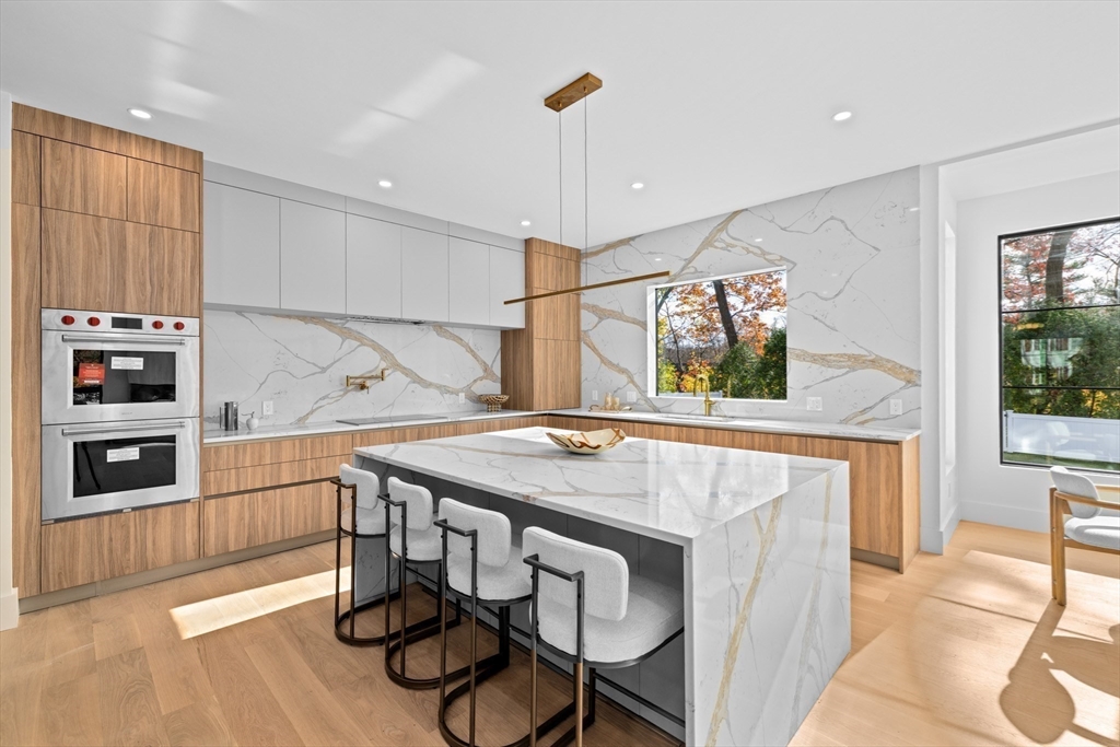 36 Roland Street Newton, MA 02461 - Photo 8 of 42 a kitchen with a table and chairs in it