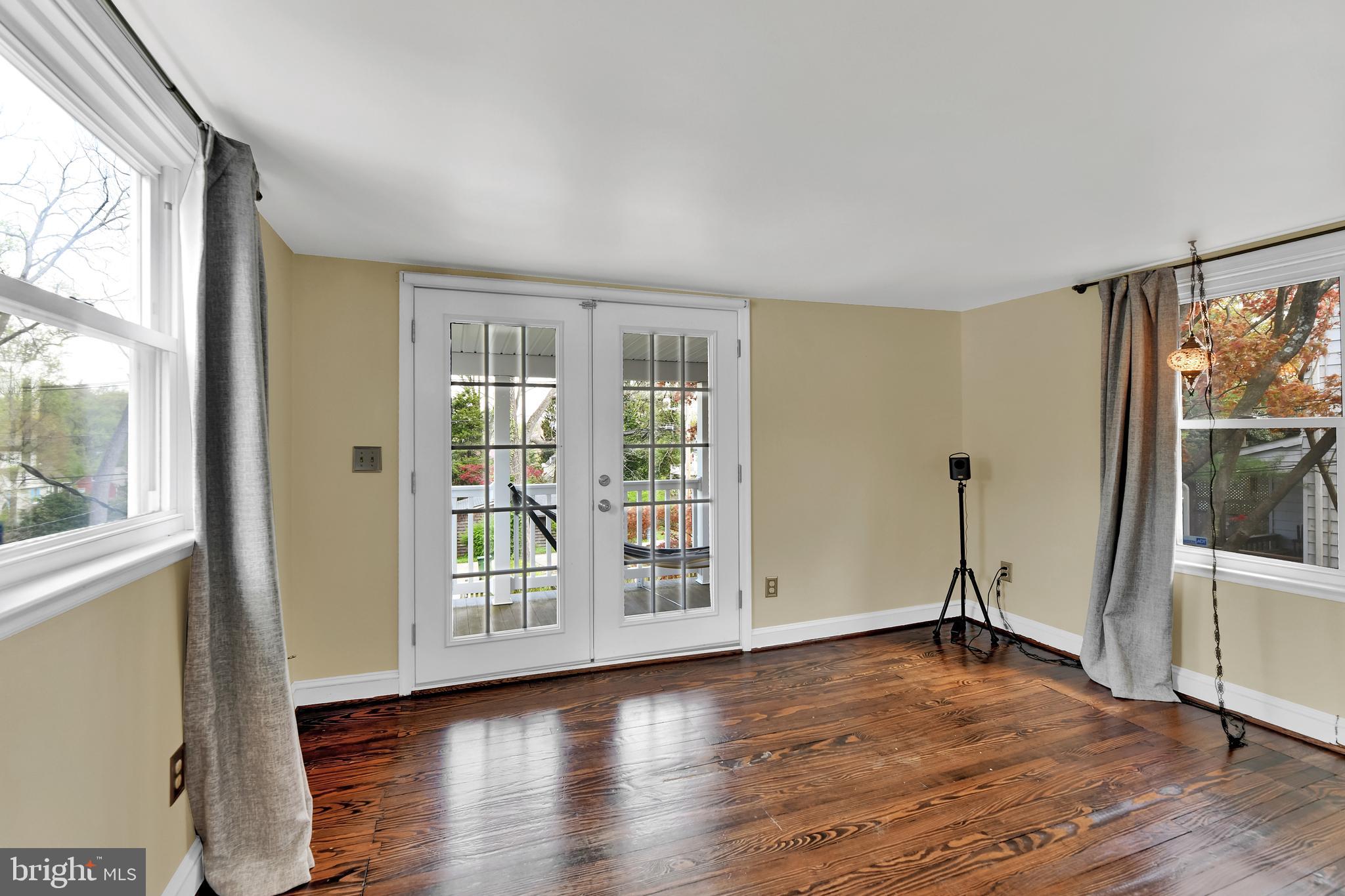 4541 Keswick Road Baltimore, MD 21210 - Photo 14 of 20 a view of an empty room with wooden floor and a window