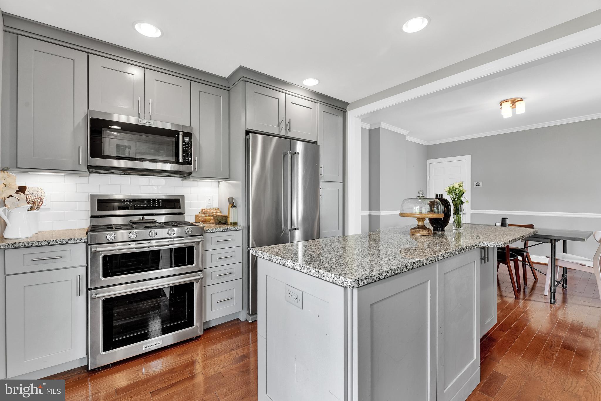 4541 Keswick Road Baltimore, MD 21210 - Photo 9 of 20 a kitchen with stainless steel appliances a stove microwave and refrigerator