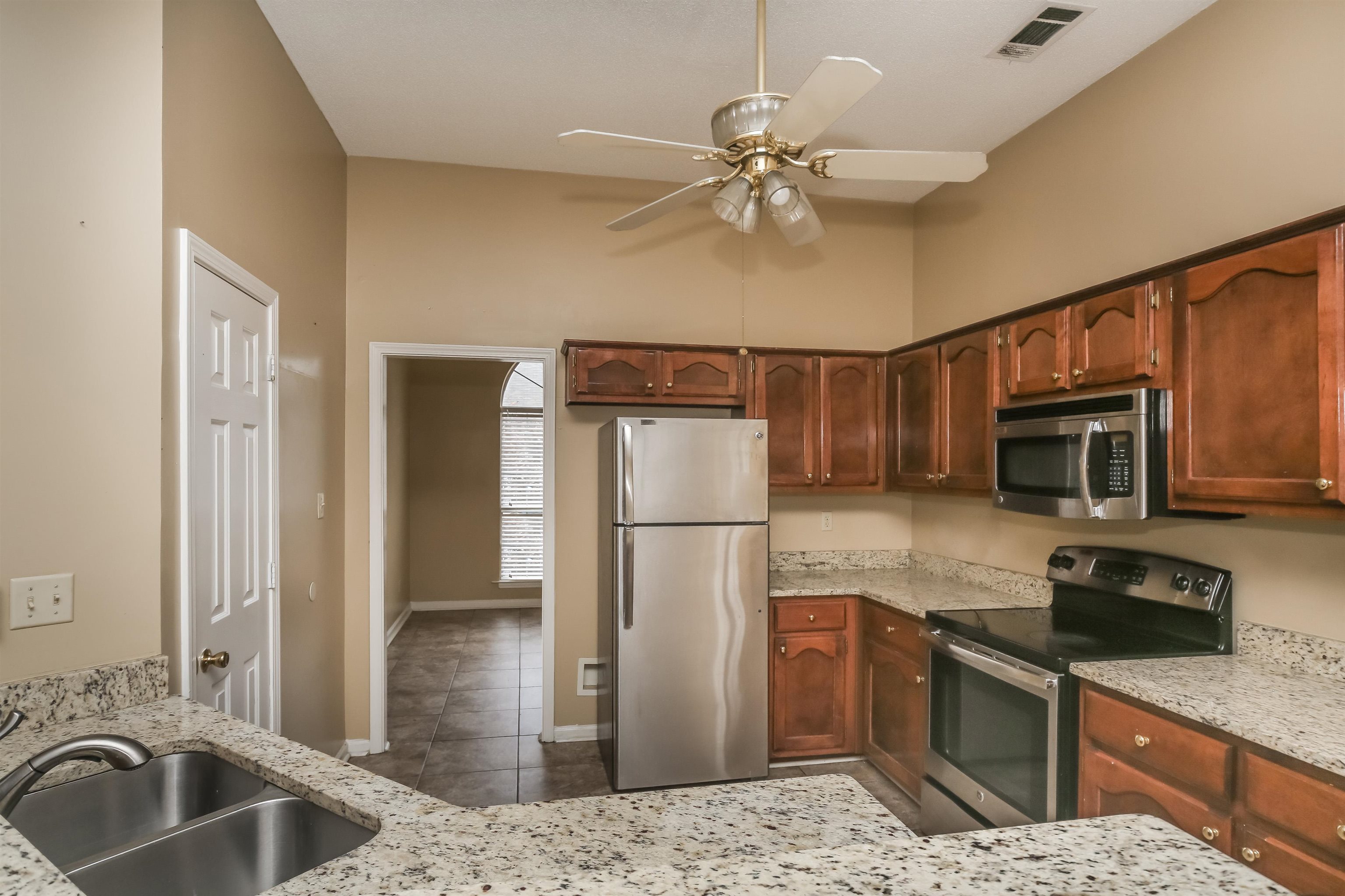 1036 Dusty Lane Cordova, TN 38018 - Photo 9 of 16 a kitchen with a refrigerator sink and microwave