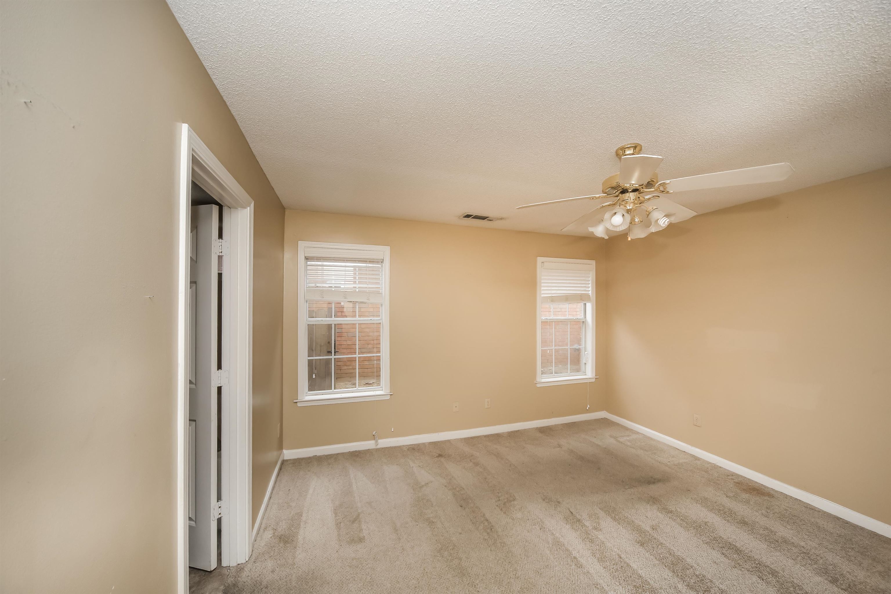 1036 Dusty Lane Cordova, TN 38018 - Photo 10 of 16 an empty room with windows and chandelier fan