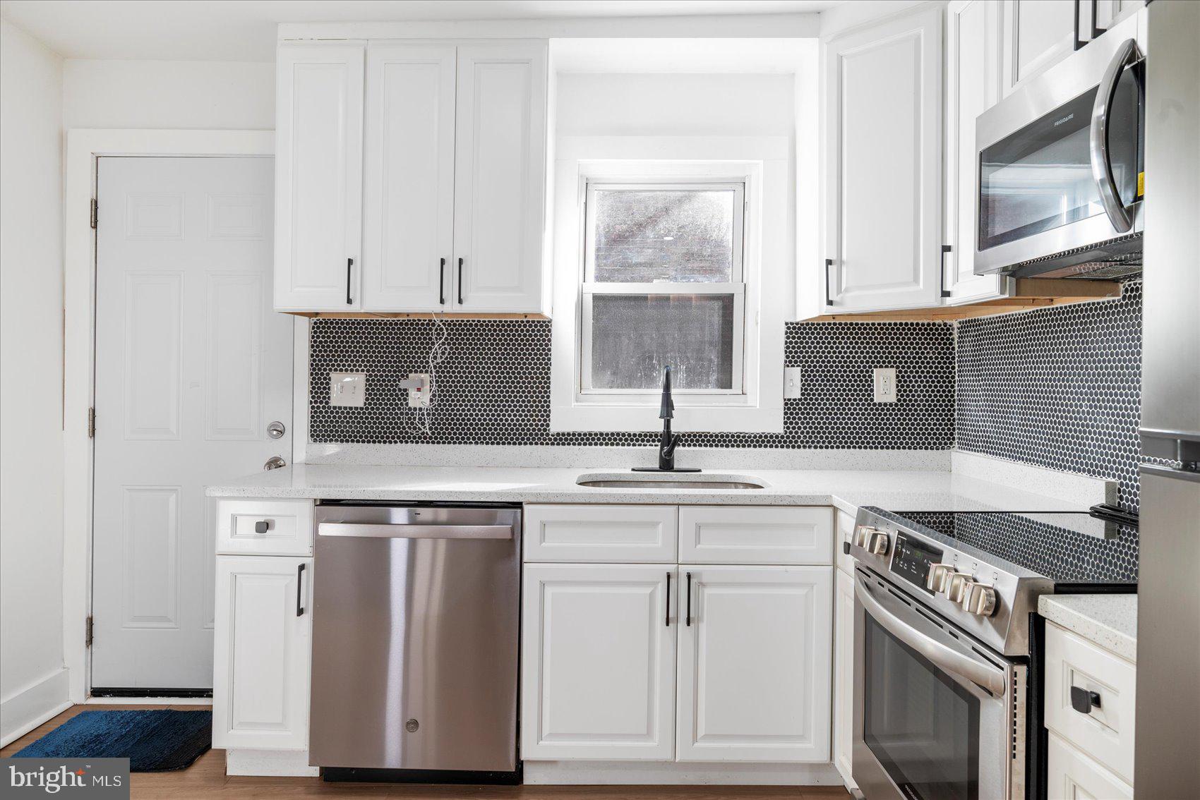 847 Reinhardt Street Baltimore, MD 21230 - Photo 12 of 41 a kitchen with cabinets appliances and a sink