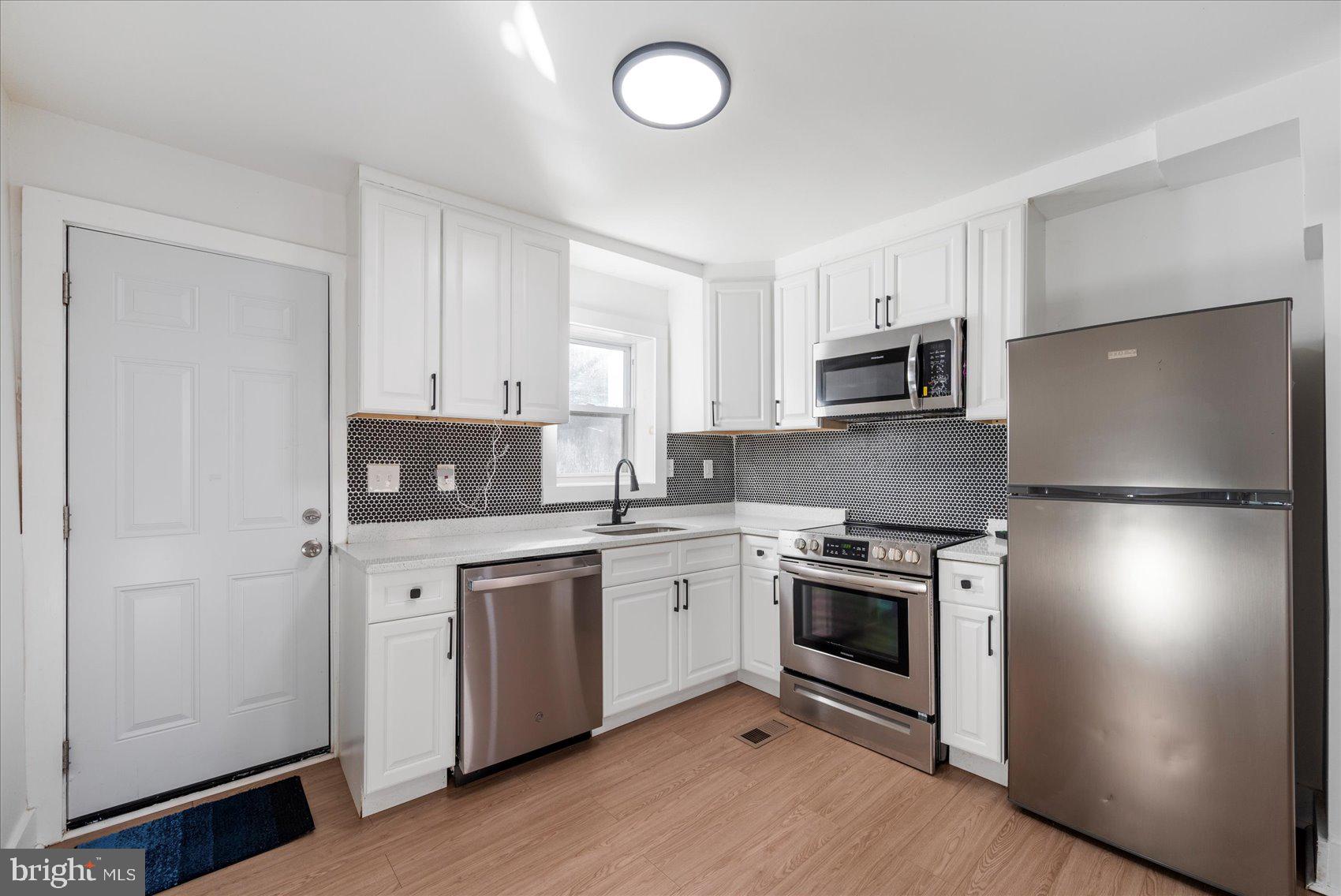 847 Reinhardt Street Baltimore, MD 21230 - Photo 14 of 41 a kitchen with cabinets stainless steel appliances and a counter space