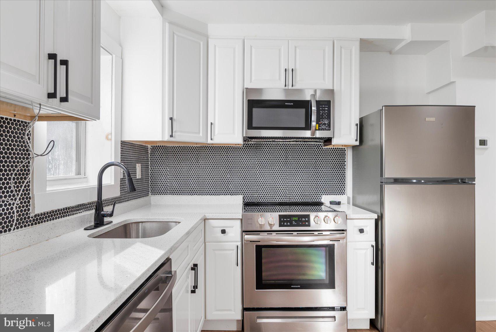 847 Reinhardt Street Baltimore, MD 21230 - Photo 15 of 41 a kitchen with cabinets stainless steel appliances and sink