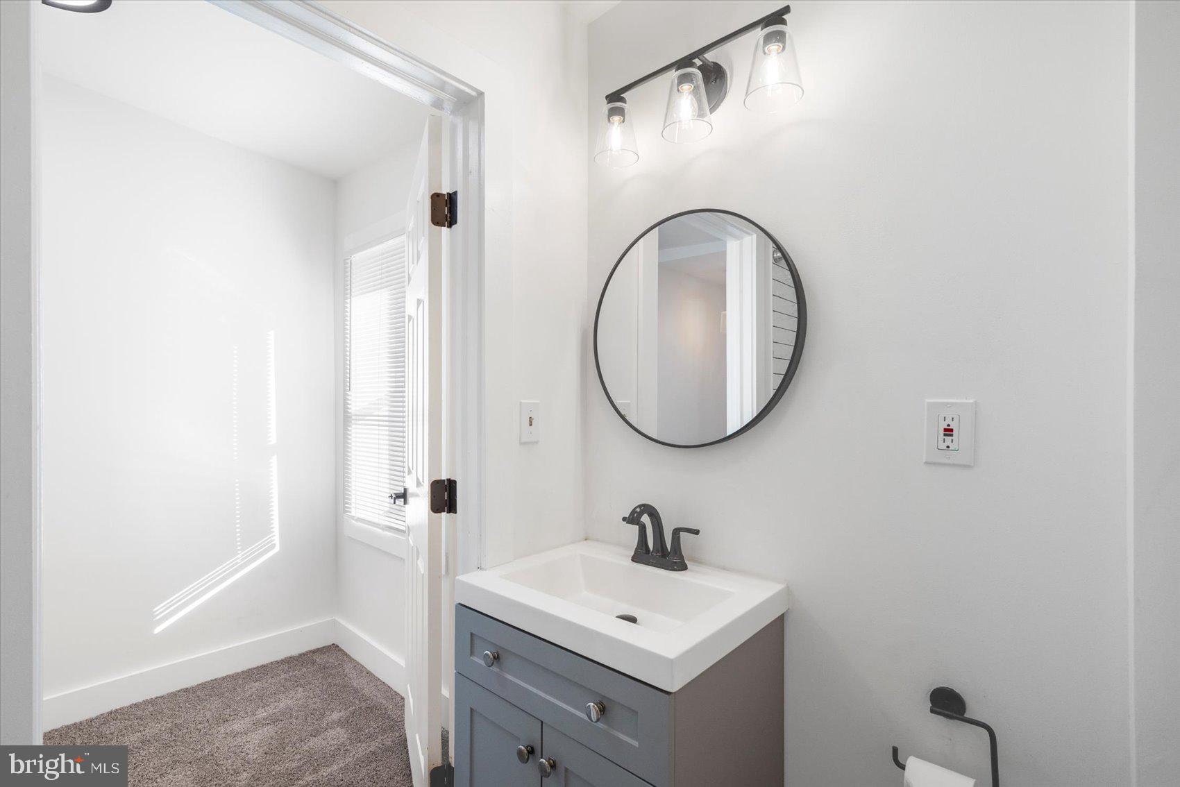 847 Reinhardt Street Baltimore, MD 21230 - Photo 24 of 41 a bathroom with a sink a mirror and a shower