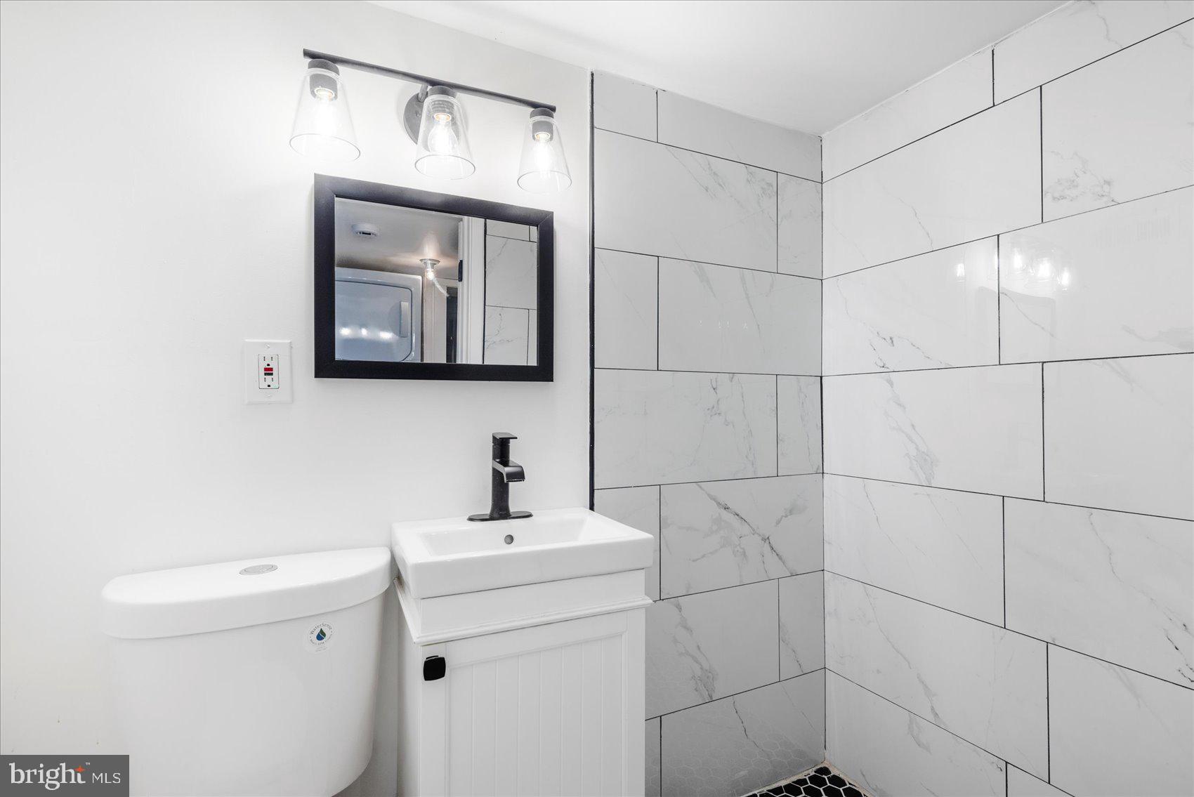 847 Reinhardt Street Baltimore, MD 21230 - Photo 31 of 41 a bathroom with a toilet sink and mirror