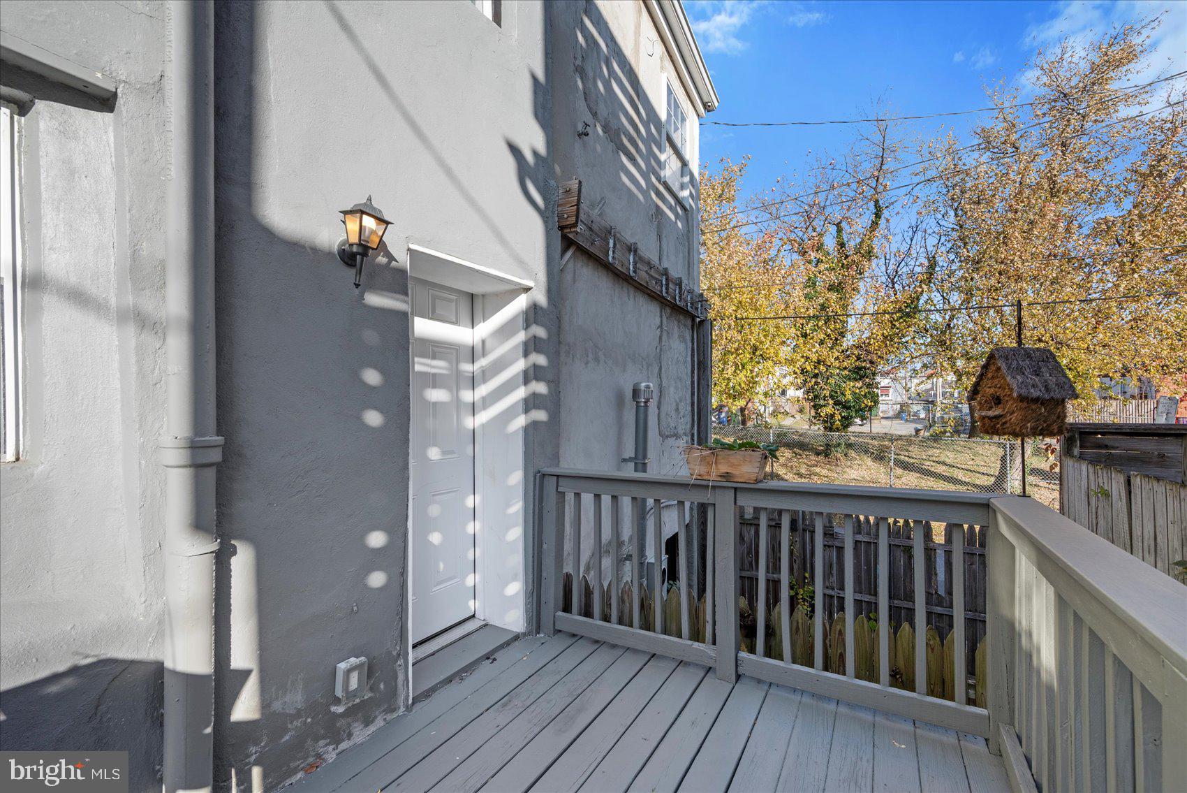 847 Reinhardt Street Baltimore, MD 21230 - Photo 40 of 41 a view of a balcony with wooden floor and fence
