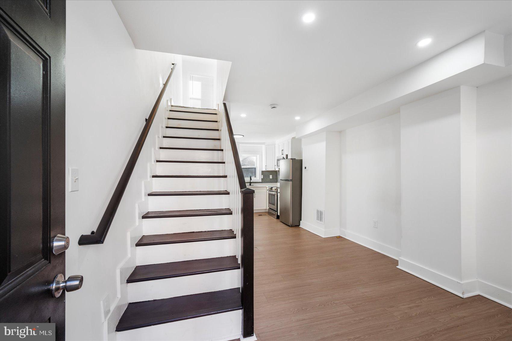 847 Reinhardt Street Baltimore, MD 21230 - Photo 5 of 41 a view of entryway with stairs and wooden floor