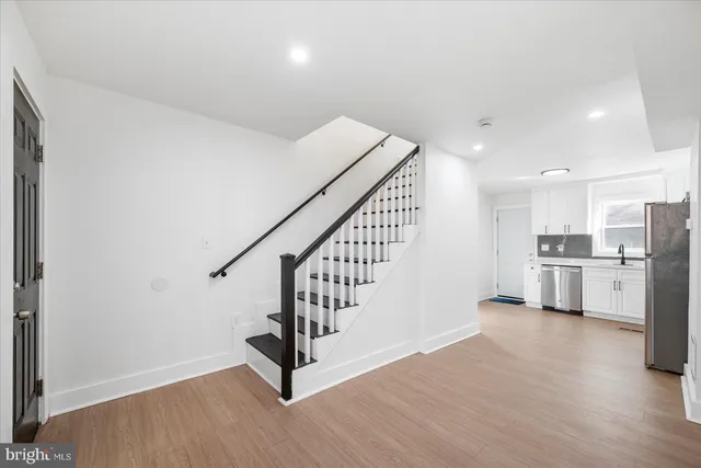 a view of a kitchen with wooden floor and electronic appliances