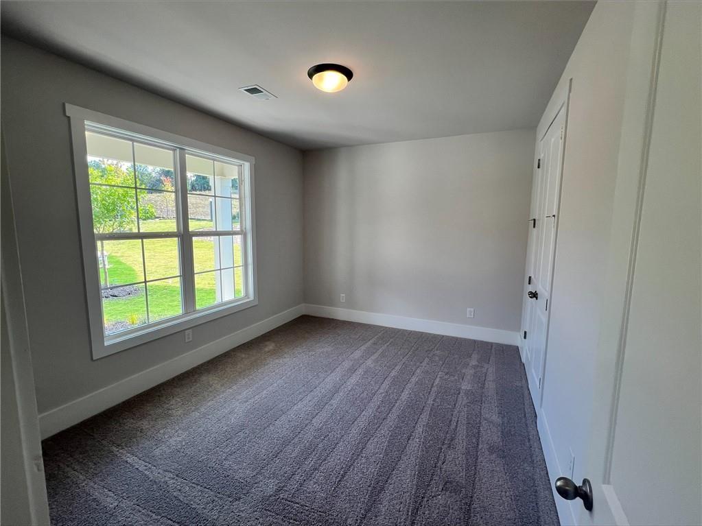 219 Willow Street Canton, GA 30114 - Photo 16 of 24 an empty room with wooden floor and windows