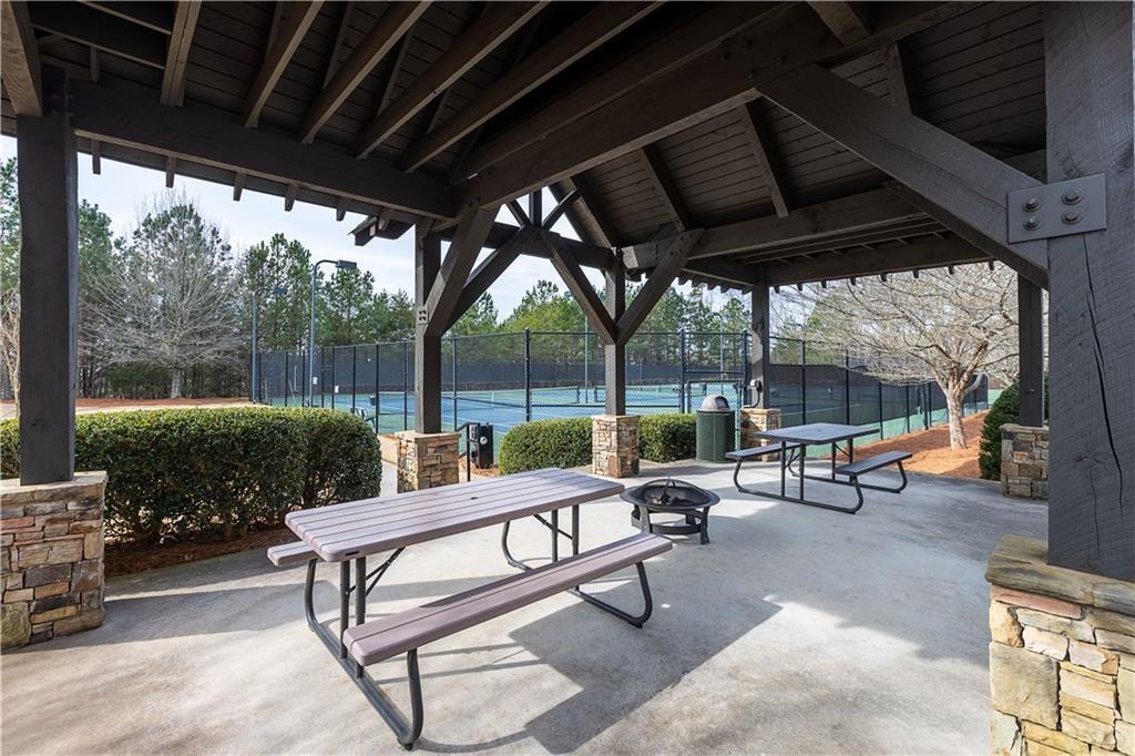 219 Willow Street Canton, GA 30114 - Photo 24 of 24 a view of a patio with a table chairs and a couple of flower plants