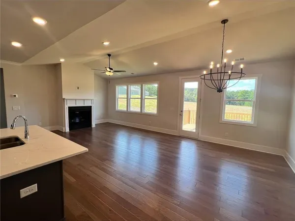 a view of a room with chandelier wooden floor and a chandelier